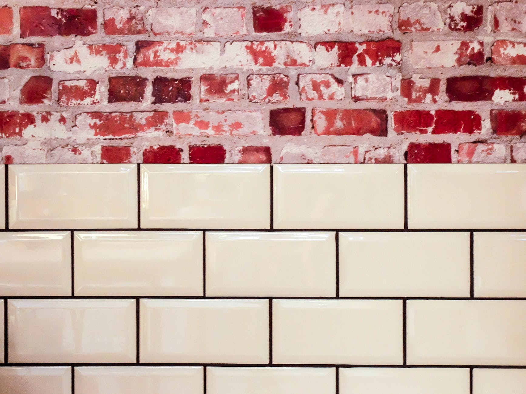white ceramic wall tile beside red concrete bricks